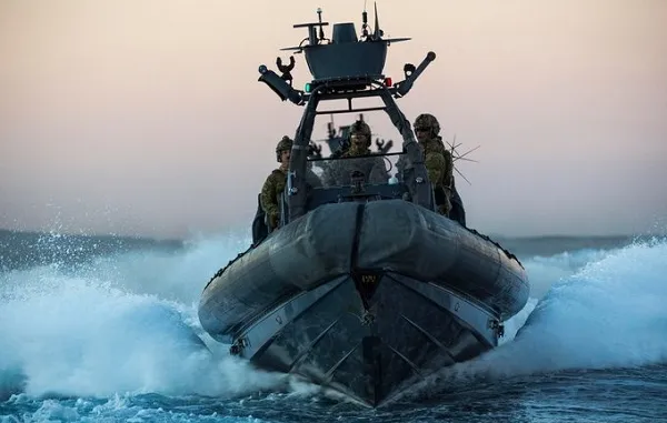 Operators on a high-speed RHIB cutting through open water