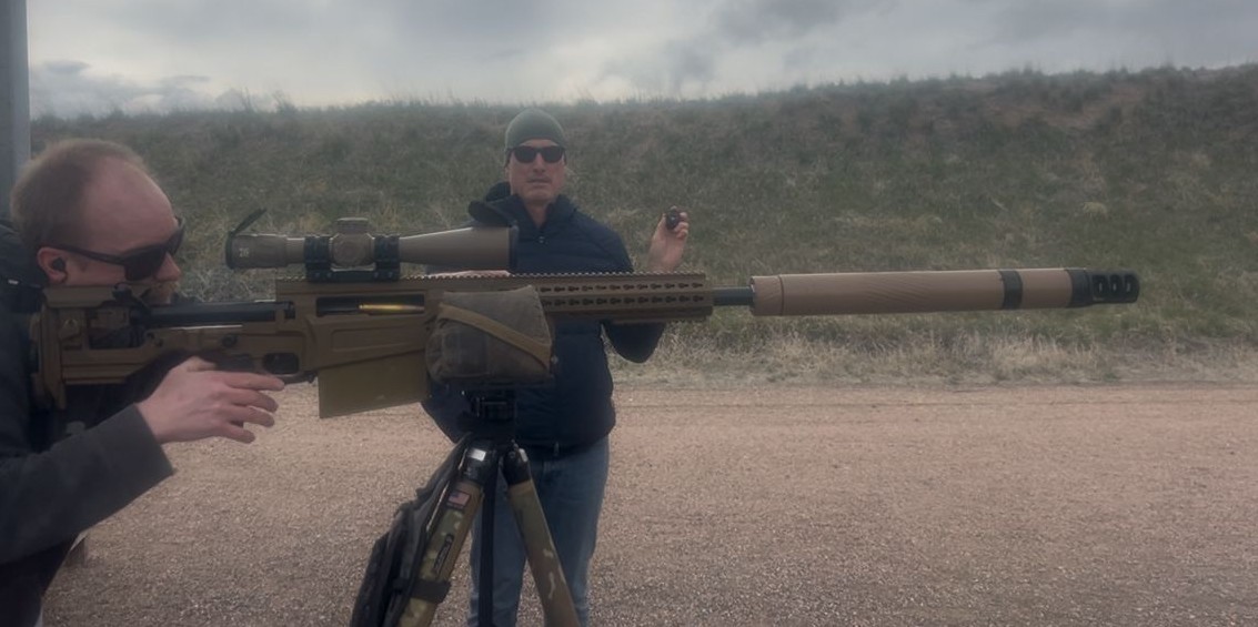 Operator firing suppressed precision rifle on the range